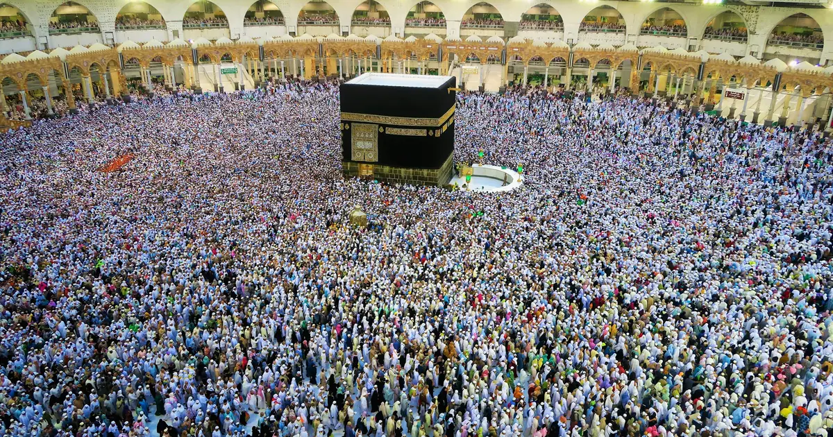 Aerial view of the Kaaba at Masjid al-Haram surrounded by hundreds of thousands of pilgrims in white Ihram during Hajj