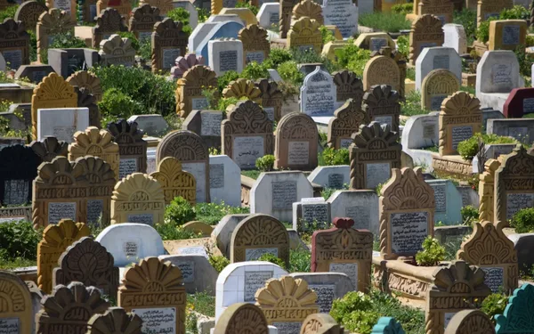 A traditional Islamic cemetery with Arabic-inscribed headstones